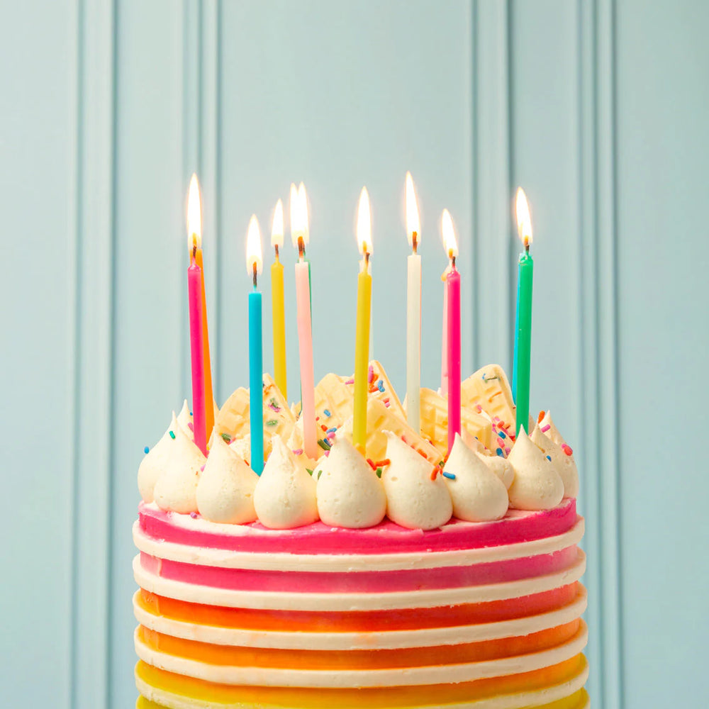 Set of 16 Rainbow Brights birthday candles from Talking Tables, colorful 10cm candles arranged on a white background.