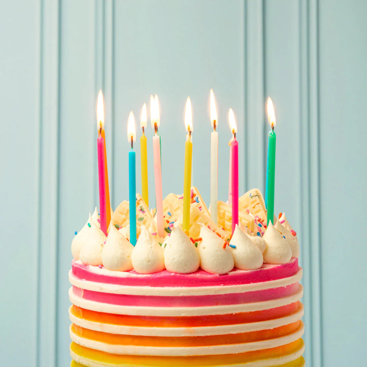 Set of 16 Rainbow Brights birthday candles from Talking Tables, colorful 10cm candles arranged on a white background.