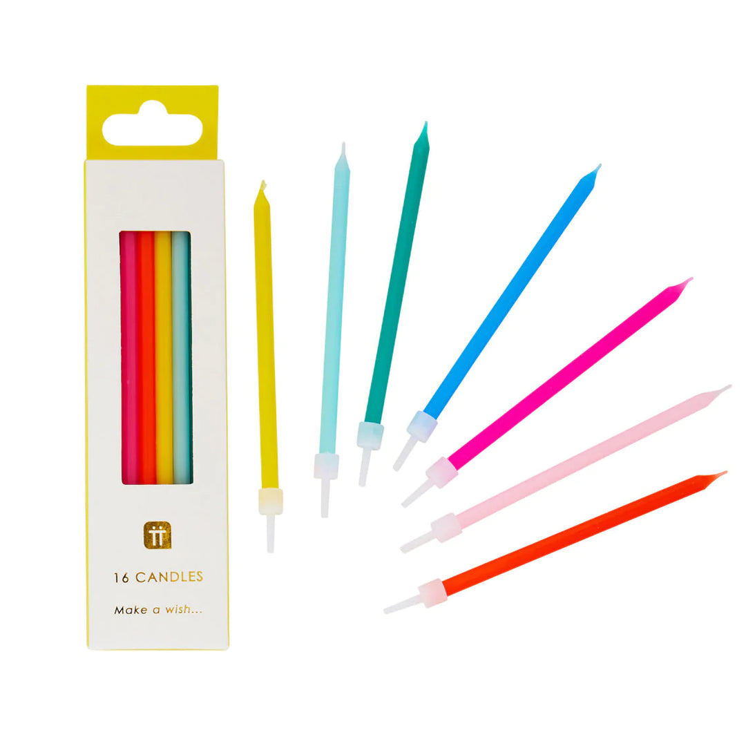 Set of 16 colorful Rainbow Brights birthday candles from Cornucopia Home and Gift, each 10cm tall, arranged on a festive table.