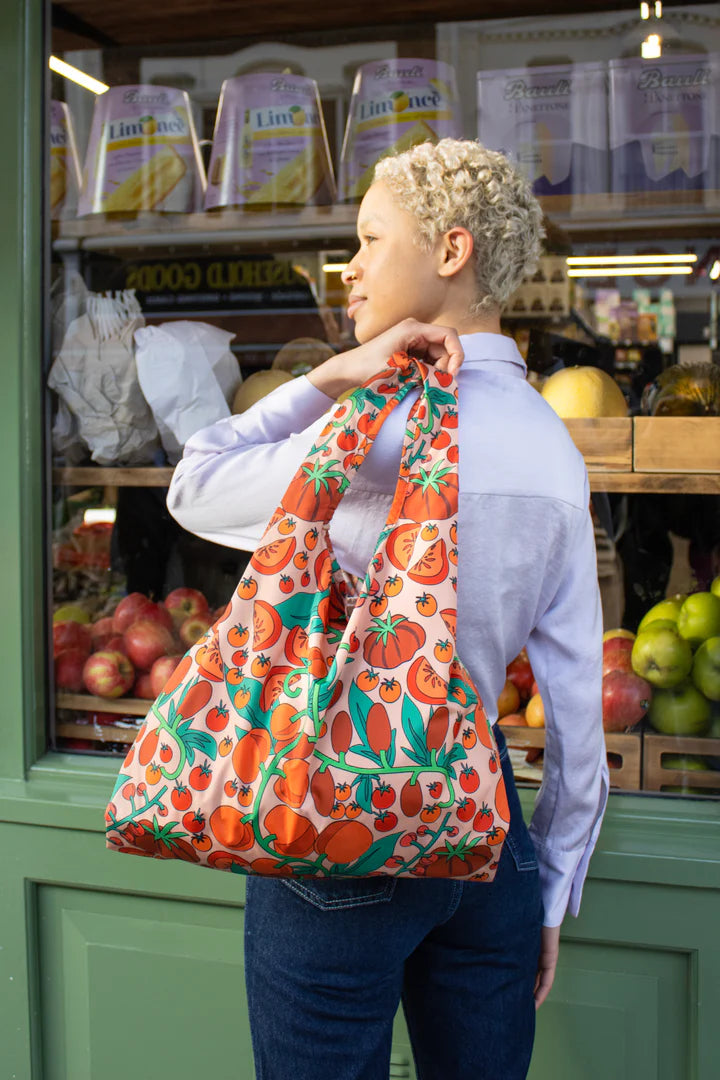 Medium pink reusable bag from Kind Bags by Cornucopia Home and Gift filled with fresh tomatoes.