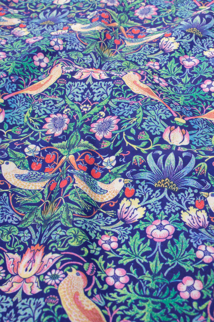 Close-up of William Morris Strawberry Thief pattern on Kind Bags by Cornucopia Home and Gift, showcasing detailed floral design.