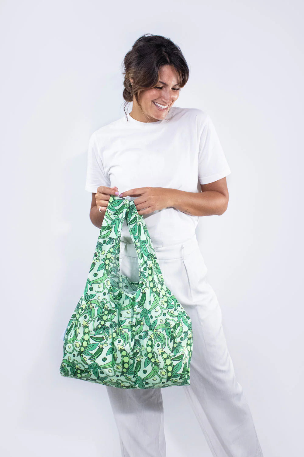 Medium reusable bag from Kind Bags by Cornucopia Home and Gift filled with fresh green peas. Eco-friendly shopping tote.