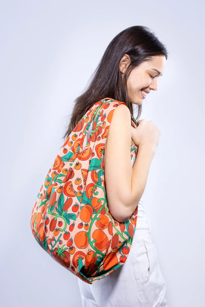 Pink reusable shoulder bag with tomatoes design from Cornucopia Home and Gift, featuring a medium-sized Kind Bags product.