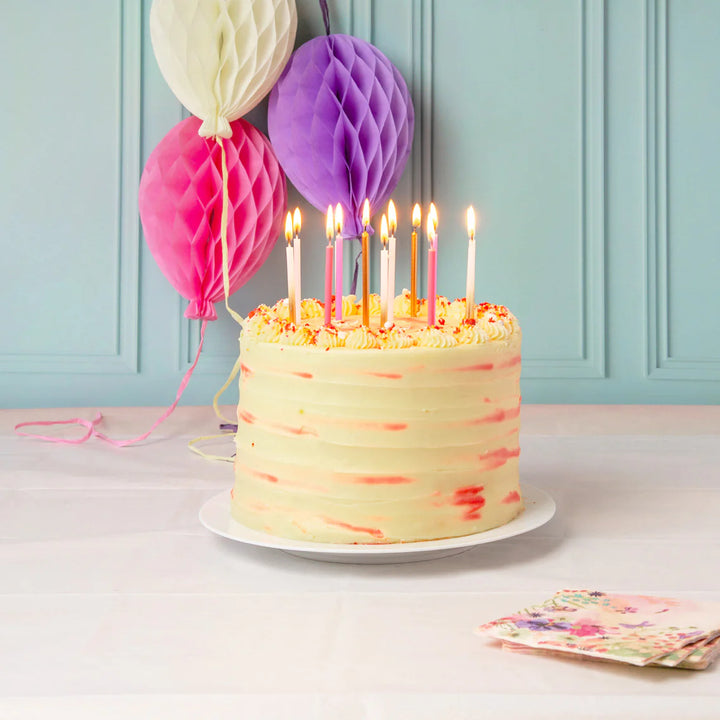 Set of 16 rose-shaped birthday candles from Cornucopia Home and Gift, 10cm tall, featuring detailed pink rose designs for celebrations