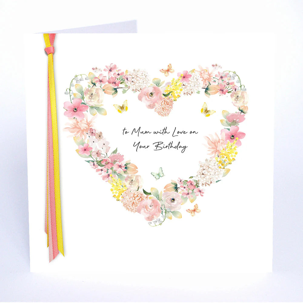 A colorful birthday card from Five Dollar Shake with "To Mum With Love" text, featuring floral and heart illustrations by Cornucopia Home and Gift.