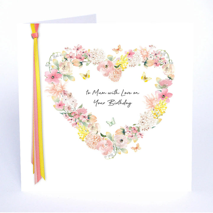 A colorful birthday card from Five Dollar Shake with "To Mum With Love" text, featuring floral and heart illustrations by Cornucopia Home and Gift.