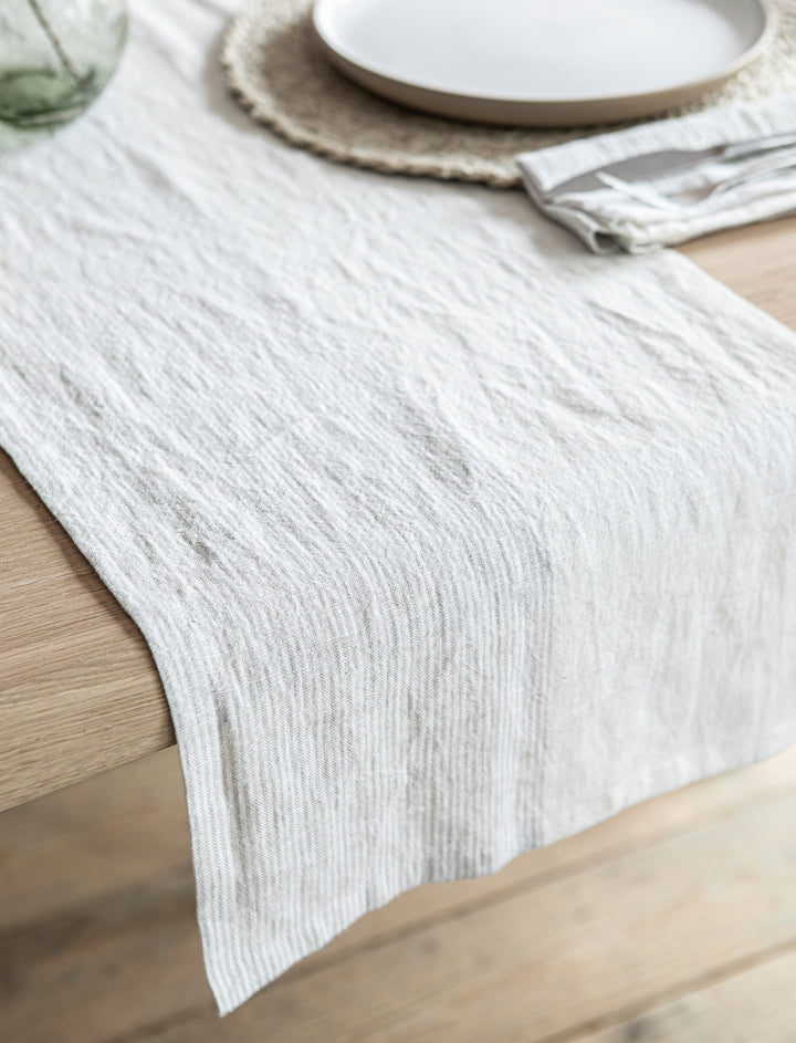 Linen Hazleton Stripe Runner in Flint from Garden Trading, showcasing a stylish table runner with blue and white stripe pattern.