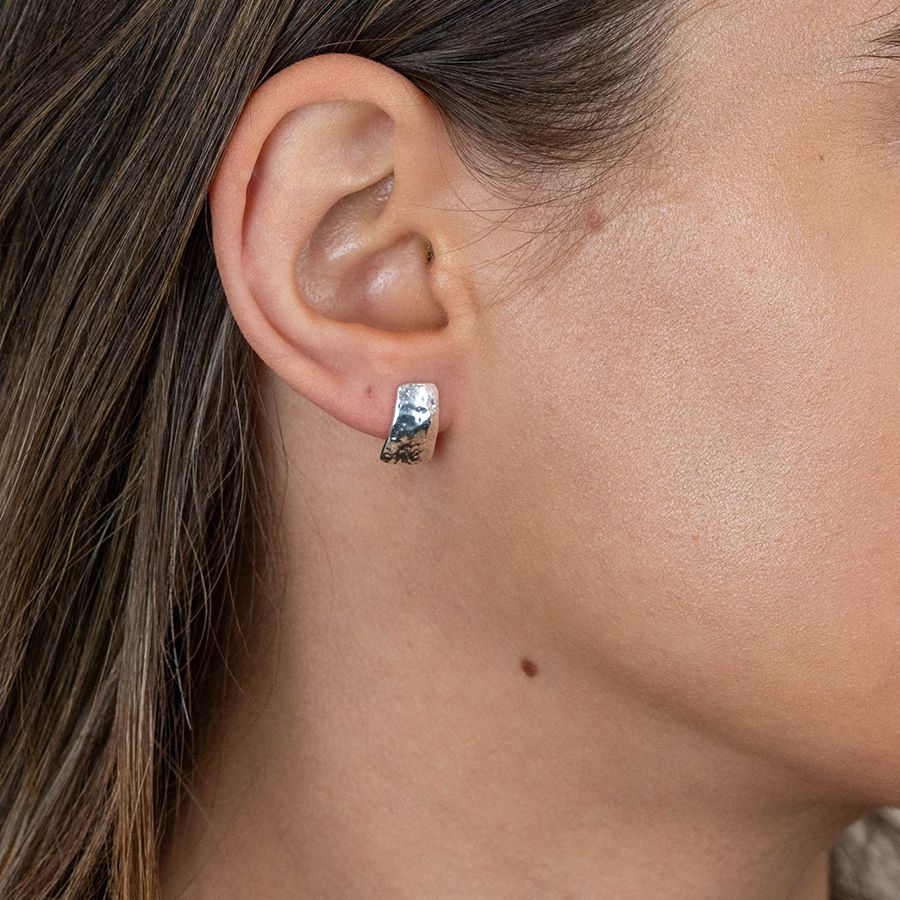 Sterling silver hammered stud earrings from POM Jewellery by Cornucopia Home and Gift, featuring a textured, shiny finish.