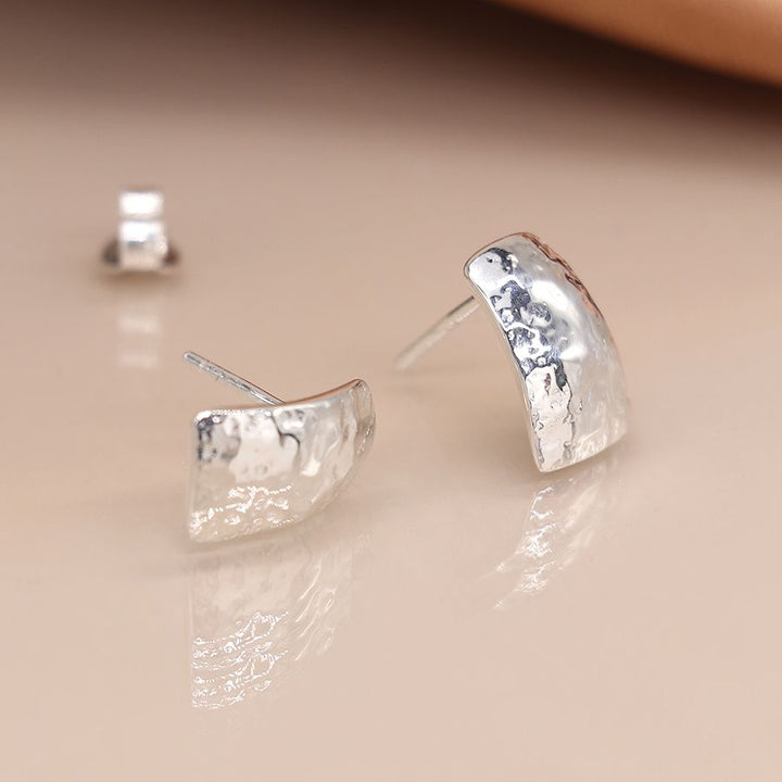 Sterling silver hammered stud earrings from POM Jewellery by Cornucopia Home and Gift, featuring a textured, shiny finish.