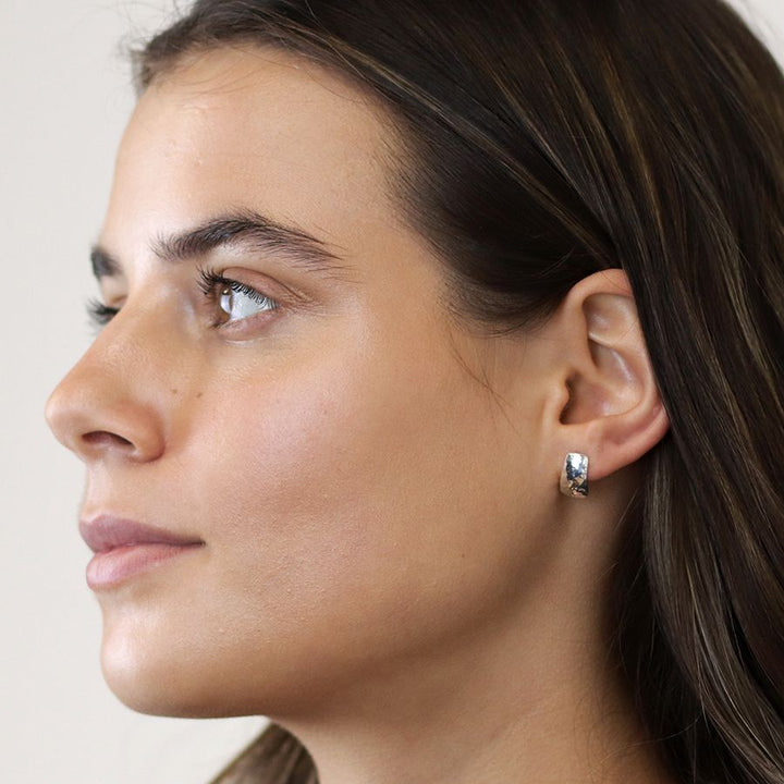 Sterling silver hammered stud earrings from POM Jewellery by Cornucopia Home and Gift, featuring a textured, shiny finish.