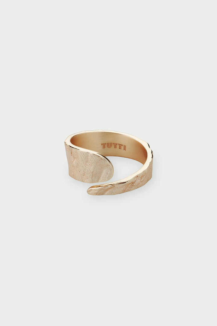 Gold Riva Ring by Tutti &amp; Co from Cornucopia Home and Gift, shown in a close-up with a textured design and shiny finish.