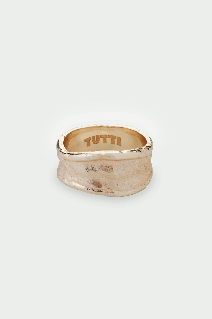 Gold Medium Driftline Ring by Tutti &amp; Co, featuring a sleek, modern design with smooth curves, displayed on a neutral background.