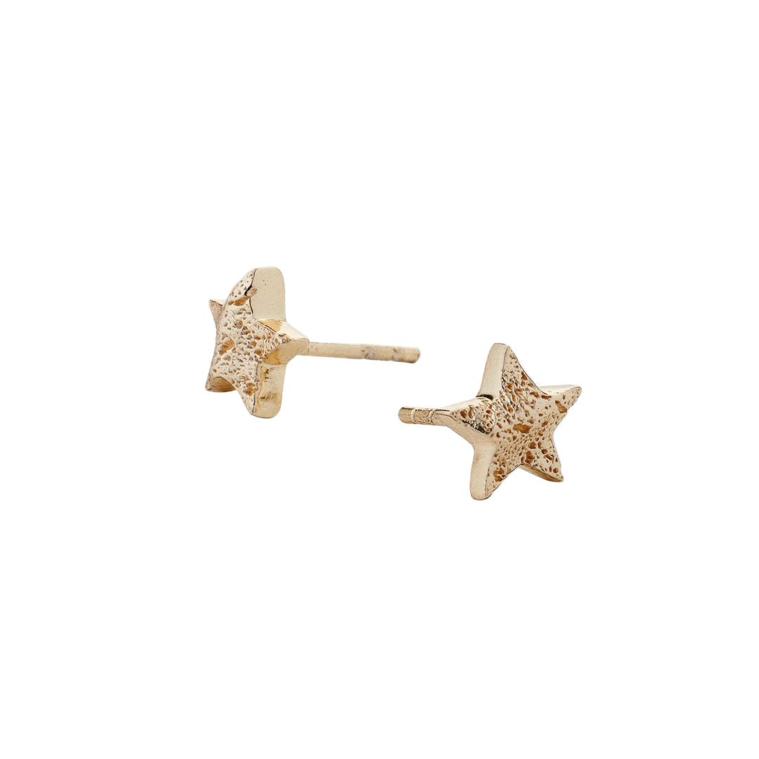 Gold Cosma earrings by Tutti & Co featuring sleek, modern design on a model's ears, showcasing stylish jewelry from Cornucopia Home and Gift.