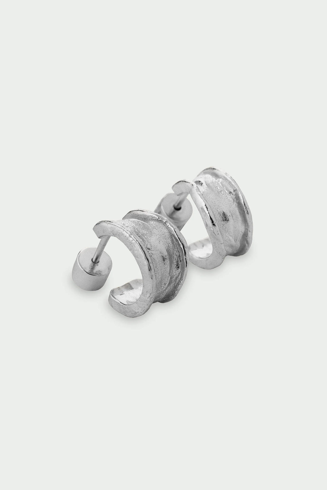 Silver Driftline Earrings by Tutti &amp; Co featuring sleek, modern design with smooth silver finish, displayed on a white background.