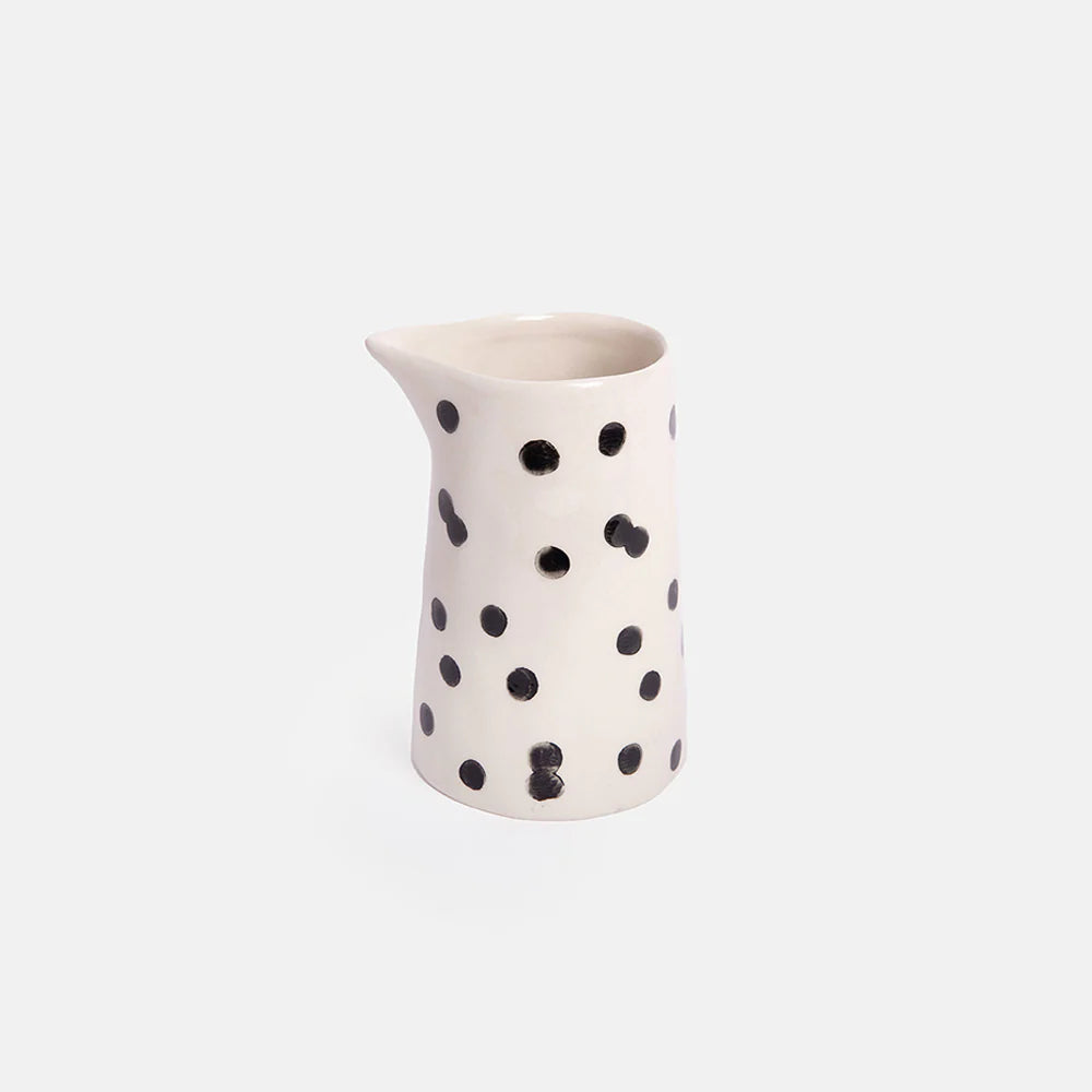 Caroline Gardner Mono Dotty Small Milk Jug with white background, featuring a playful polka dot design and a smooth ceramic finish.