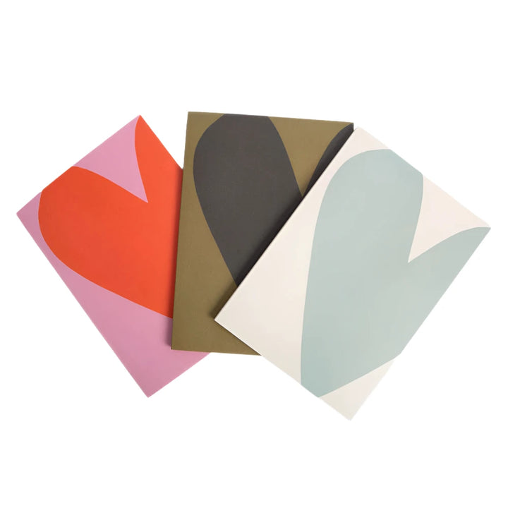 Set of three Caroline Gardner Colourblock Hearts notebooks featuring vibrant heart designs, perfect for gifting or note-taking.