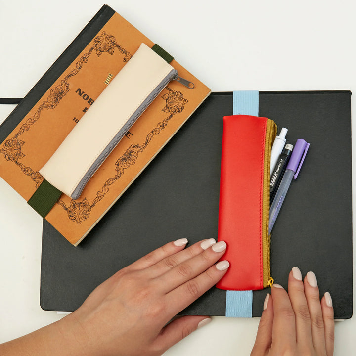 Kikkerland assorted pencil pouch with colorful fabric design, compact storage for pencils and small stationery items.