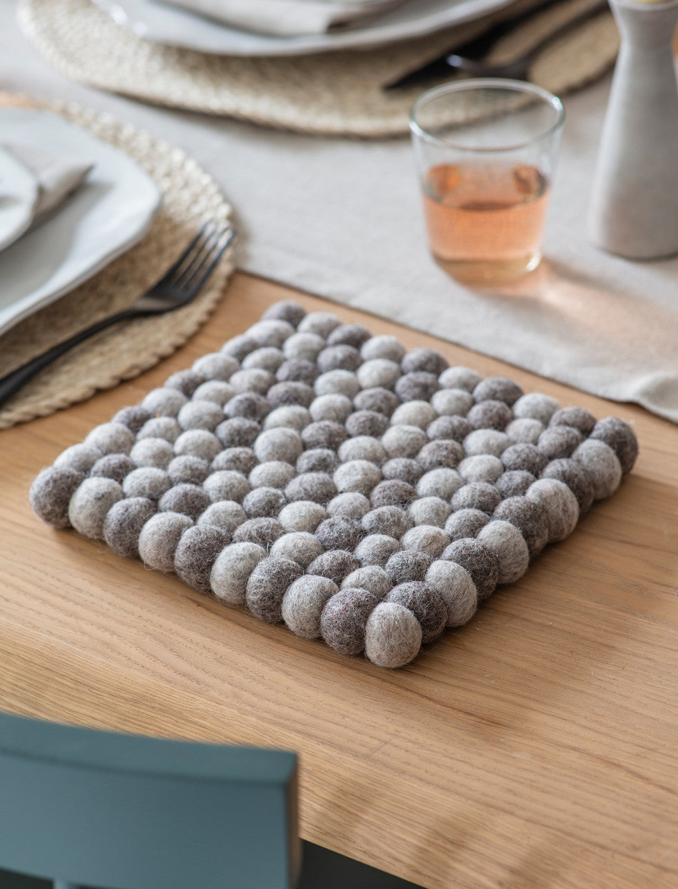 Grey Felt Southwold Square Trivet by Garden Trading, shown in a portrait view, ideal for protecting surfaces from hot items.