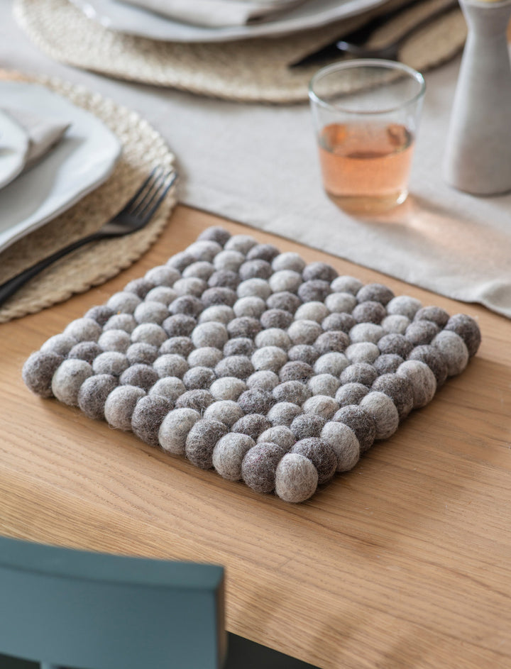 Grey Felt Southwold Square Trivet by Garden Trading, shown in a portrait view, ideal for protecting surfaces from hot items.