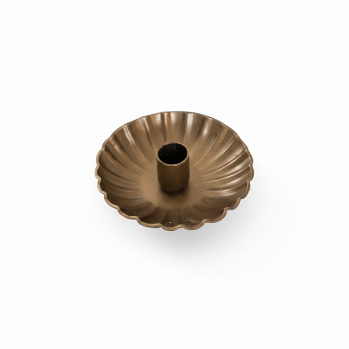 Gold decorative bowl on a wooden surface with a blurred background