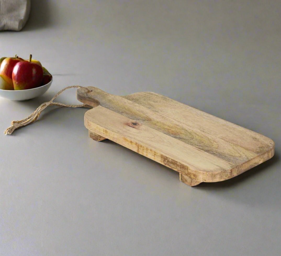 Mango wood chopping and serving board by Cornucopia Home and Gift, featuring a smooth, natural wood finish.