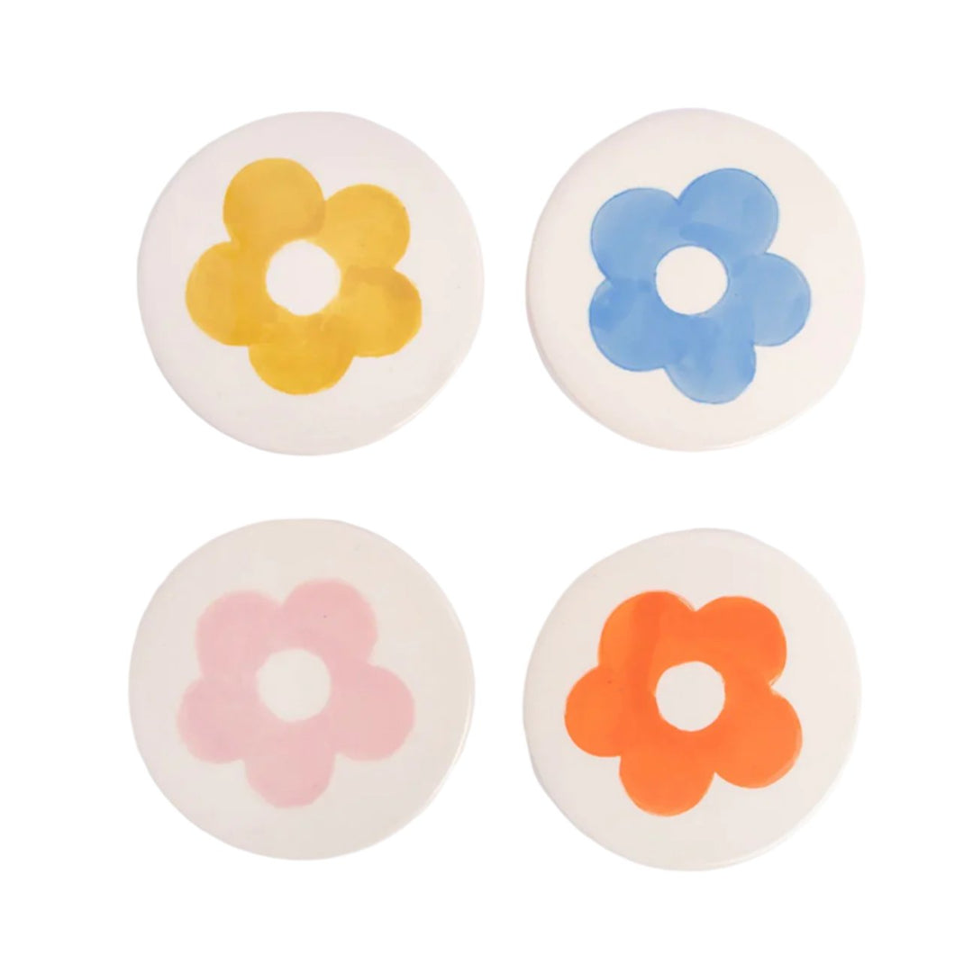 Set of four Caroline Gardner floral stoneware coasters featuring colorful botanical designs, perfect for protecting surfaces.