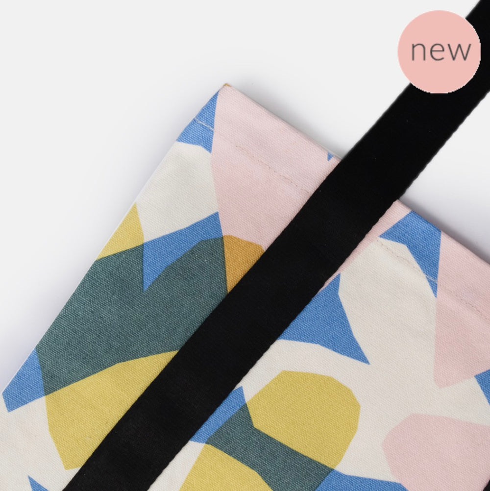 Caroline Gardner Confetti Heats book bag with colorful confetti design, featuring a zipper closure and adjustable strap for easy carrying.