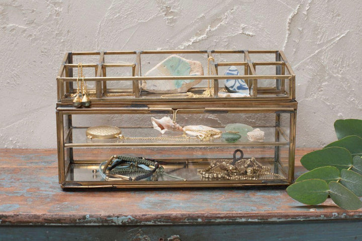 Antique brass Nkuku Bequai open jewelry box with intricate detailing and a vintage-inspired design for storing jewelry.