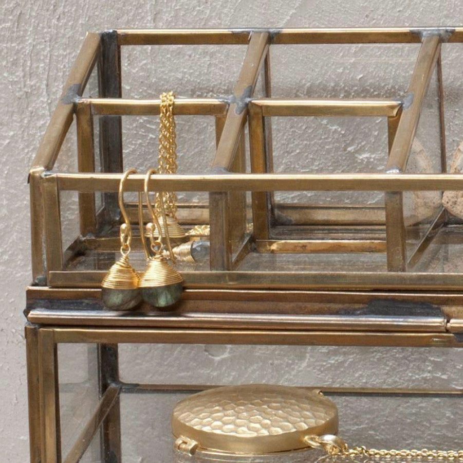 Antique brass Nkuku Bequai open jewelry box with intricate design and vintage style, perfect for storing rings and necklaces.