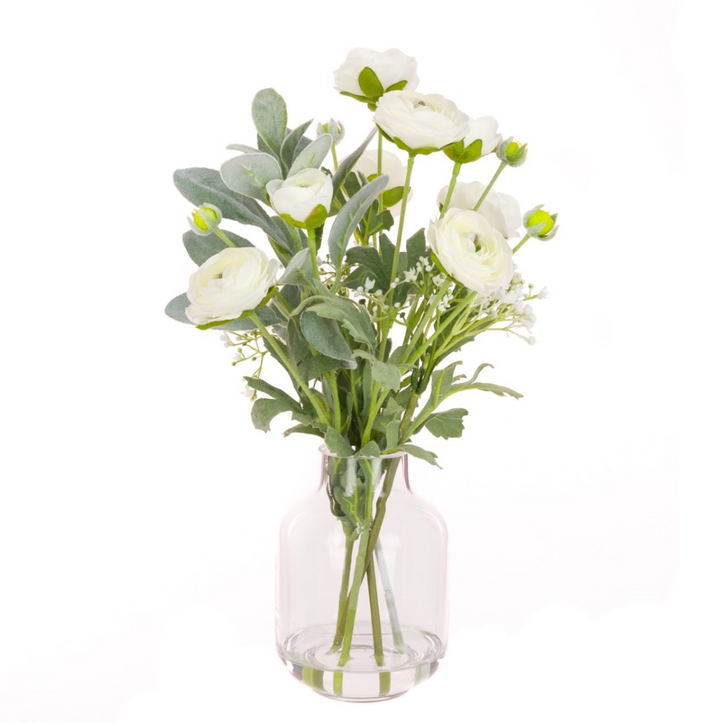 White Ranunculus silk flowers arranged in a clear bottle vase, styled by Cornucopia Home and Gift, perfect for floral decor.