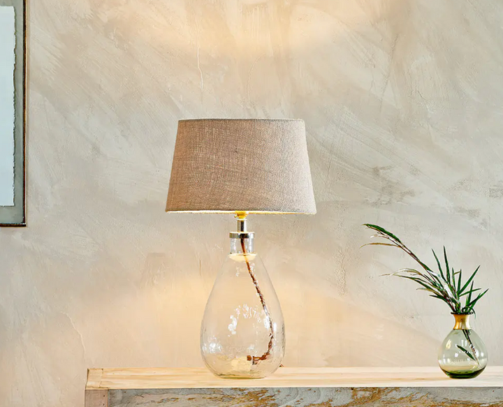 Small tall clear Baba glass lamp by Nkuku with a sleek, minimalist design, perfect for modern home decor.