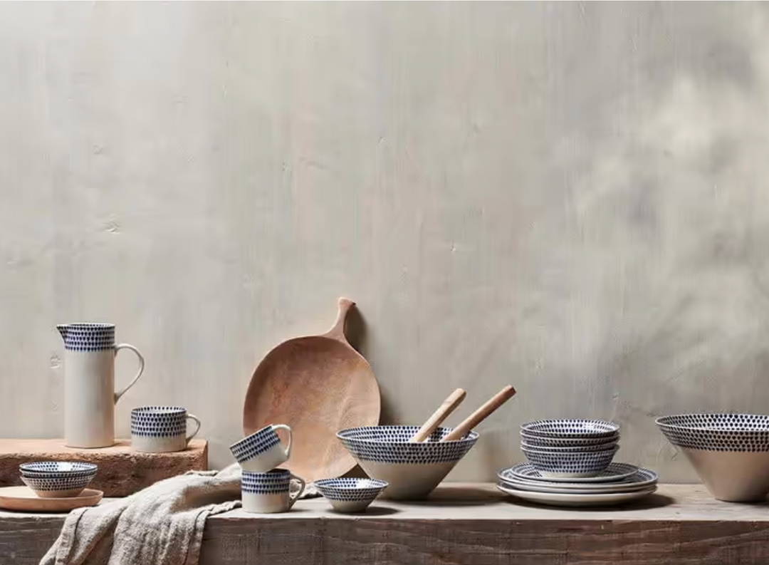Indigo Drop Side Plate by Nkuku, ceramic tableware with a blue and white drop pattern, featuring a side lip for serving.