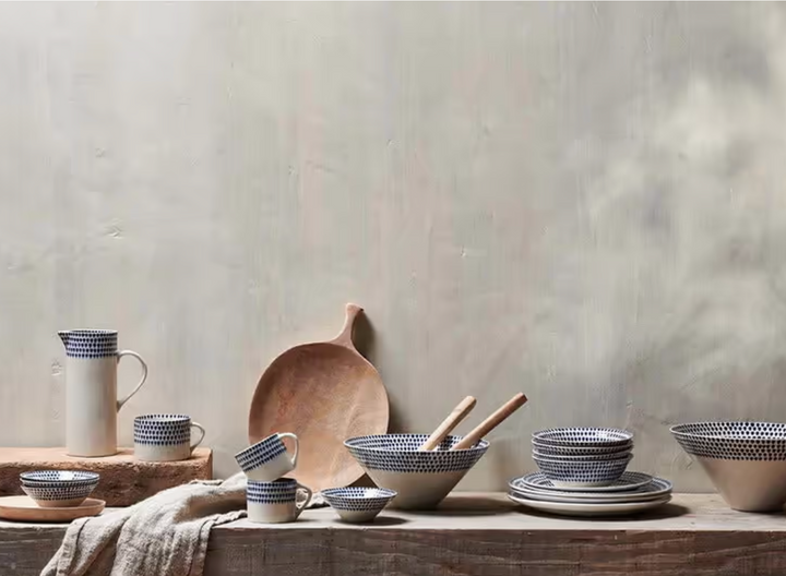 Indigo Drop Side Plate by Nkuku, ceramic tableware with a blue and white drop pattern, featuring a side lip for serving.