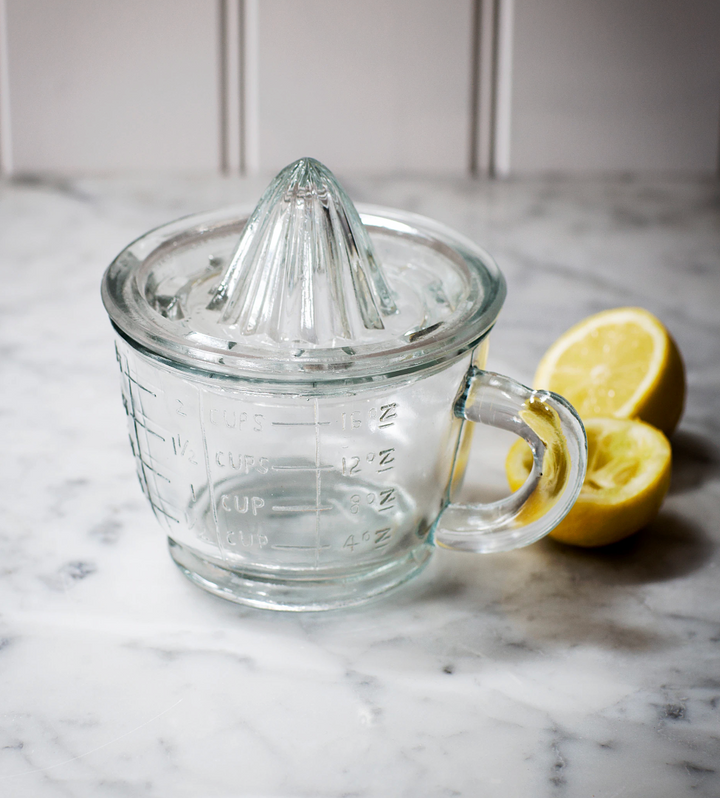 Garden Trading Classic Glass Juicer with sturdy handle and vibrant orange pulp, ideal for fresh citrus juice extraction.