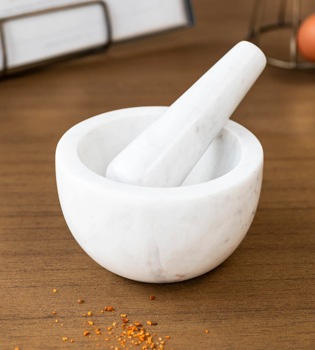 White Brompton Pestle and Mortar from Garden Trading by Cornucopia Home and Gift, shown on a countertop.