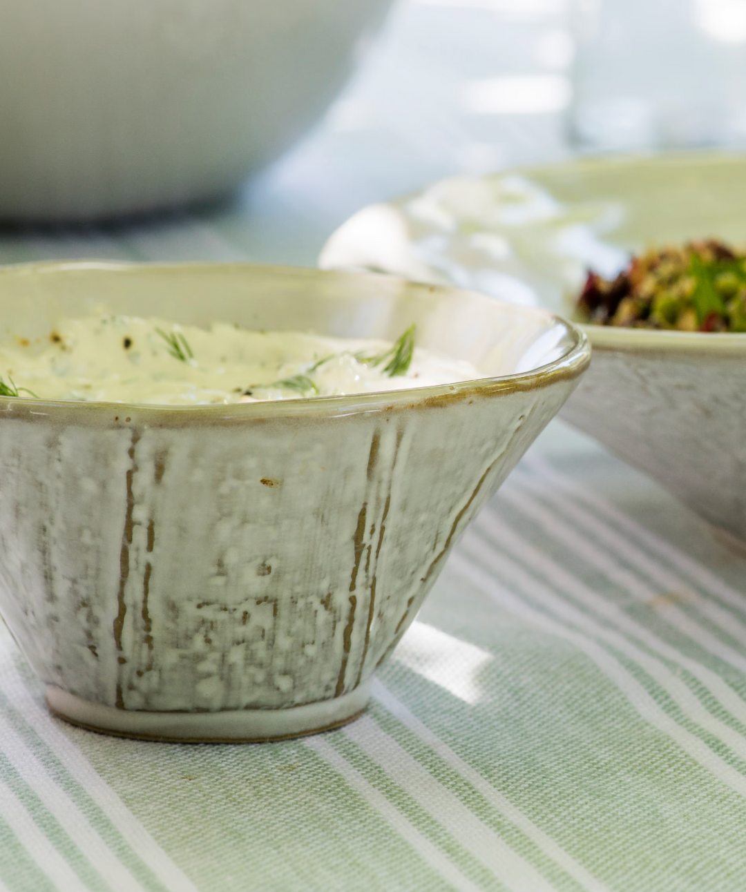 White Ithaca Meze Bowl with Spoon from Garden Trading, ideal for serving small dishes in a stylish kitchen setting.