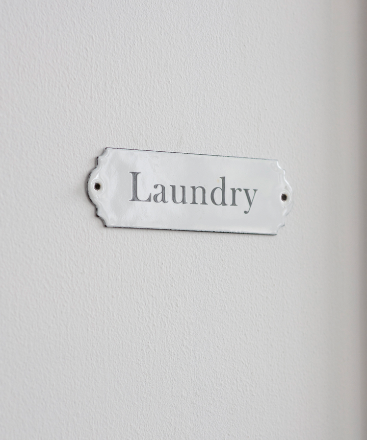 White enamel laundry sign with "Laundry" lettering from Garden Trading, designed by Cornucopia Home and Gift.