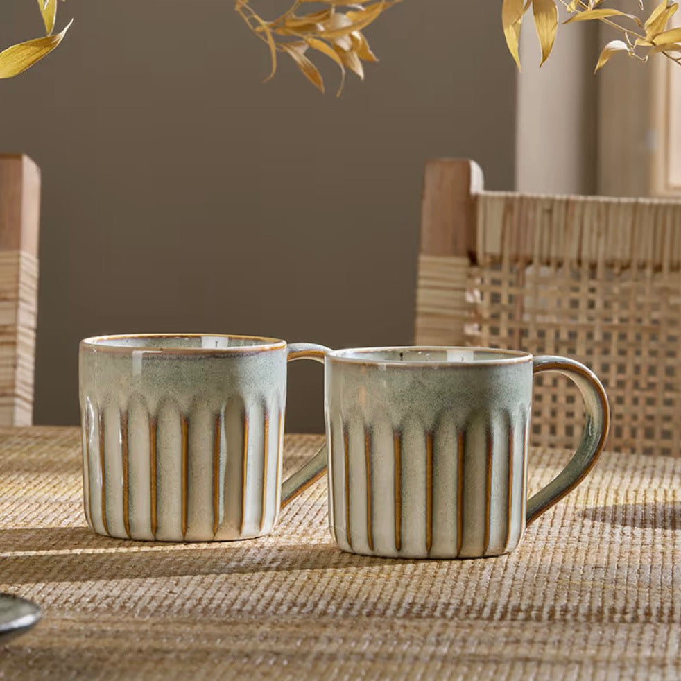 Set of two Nkuku Moda Natural mugs with earthy ceramic finish, perfect for everyday use and stylish table settings.