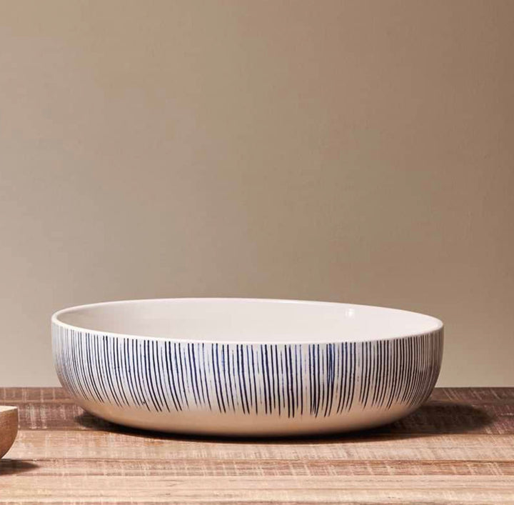 Nkuku Karuma ceramic serving bowl with a stylish design, perfect for serving dishes in a modern home setting.