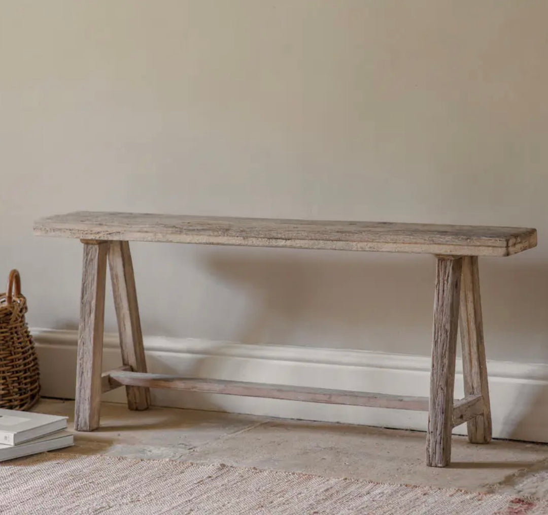 Nkuku Ibo Long Bench made of reclaimed wood, showcasing a rustic design with sturdy, natural wood planks for seating and decor.