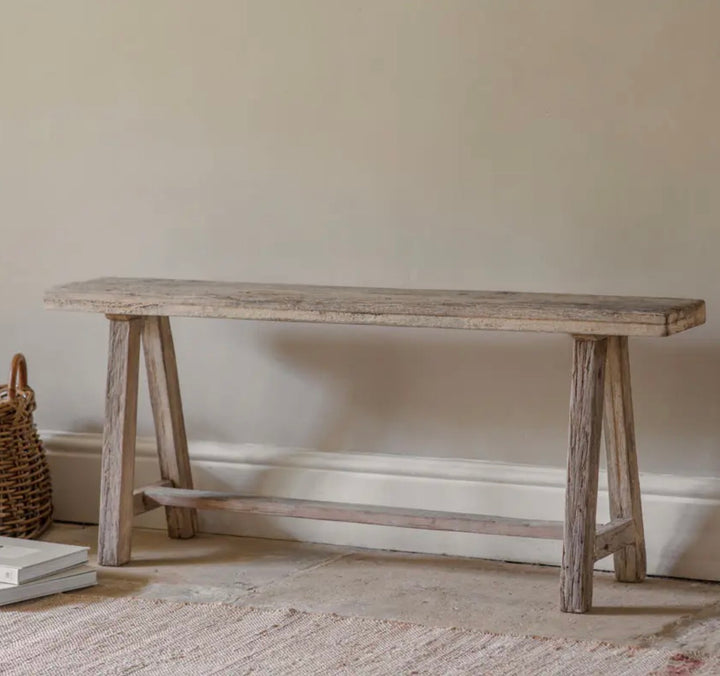 Nkuku Ibo Long Bench made of reclaimed wood, showcasing a rustic design with sturdy, natural wood planks for seating and decor.