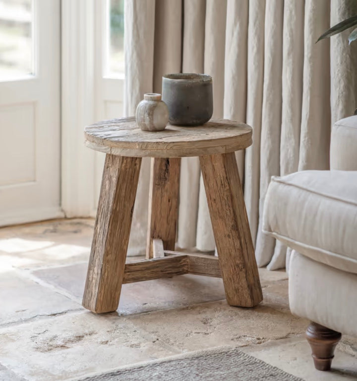 Nkuku Ibo reclaimed wood round side table in natural finish, featuring a rustic, sturdy design with a smooth tabletop.