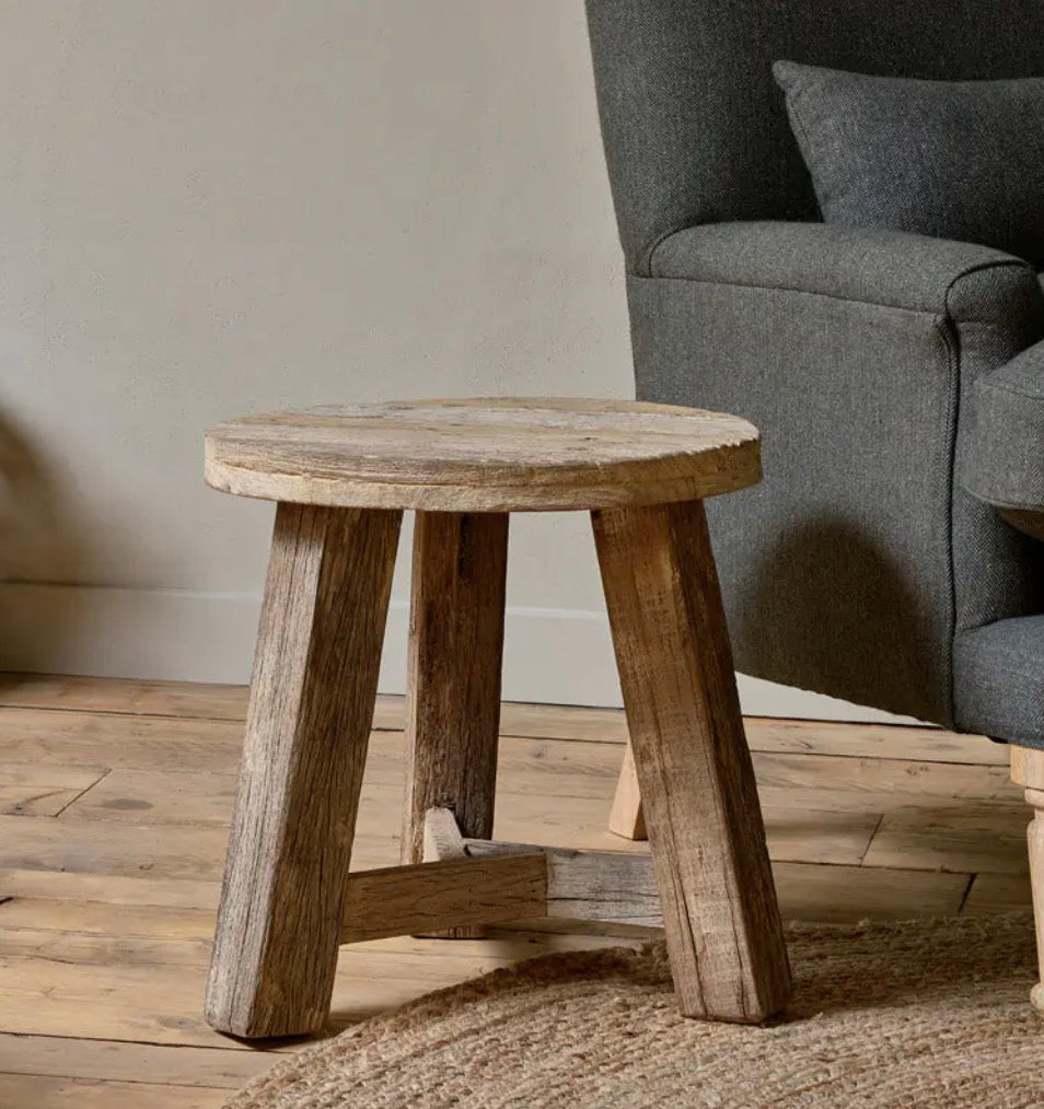 Nkuku Ibo reclaimed wood round side table in natural finish, showcasing a rustic, handcrafted design with smooth circular surface.