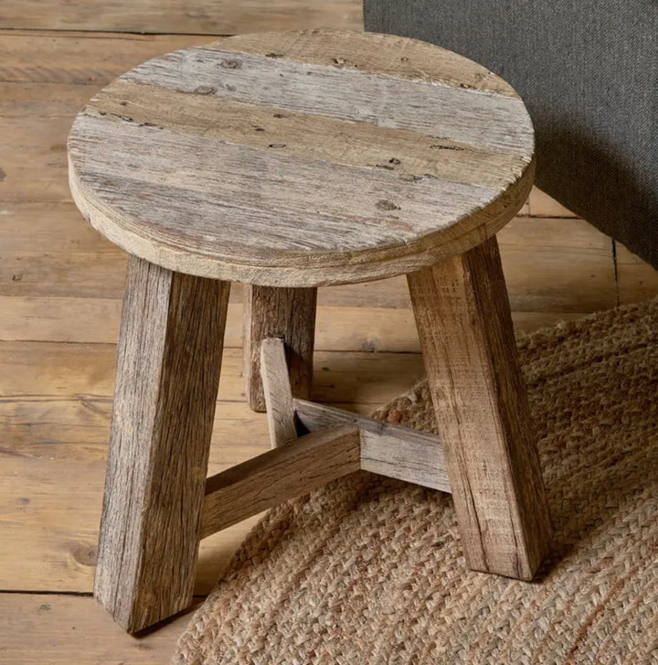 Nkuku Ibo reclaimed wood round side table in natural finish, showcasing its rustic, eco-friendly wooden surface and simple design.