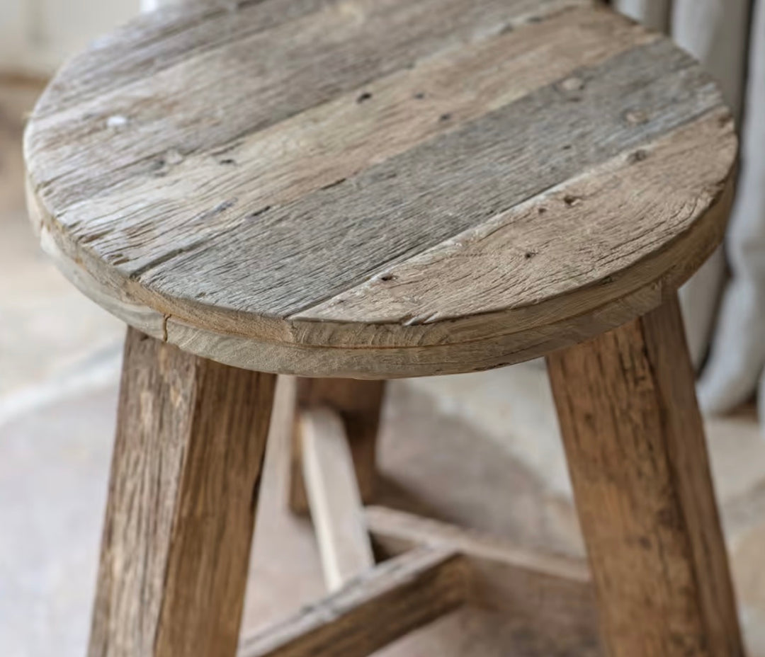 Nkuku Ibo reclaimed wood round side table in natural finish, featuring a rustic design with a sturdy wooden top and natural grain details.