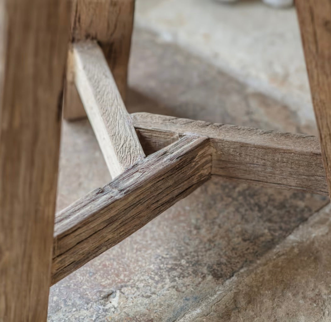 Nkuku Ibo reclaimed wood round side table in natural finish, showcasing its rustic, handcrafted design and smooth wooden surface.