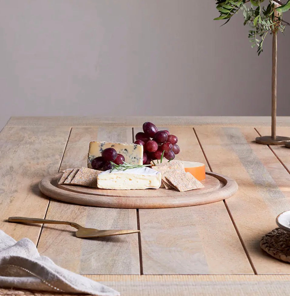 Recycled glass cake dome by Nkuku, clear and eco-friendly, with a rounded shape and wooden base for displaying baked goods.