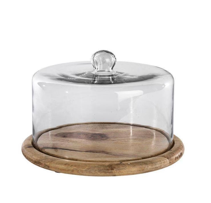 Recycled glass cake dome by Nkuku featuring a clear, rounded cover and sturdy base, perfect for displaying baked goods gracefully.