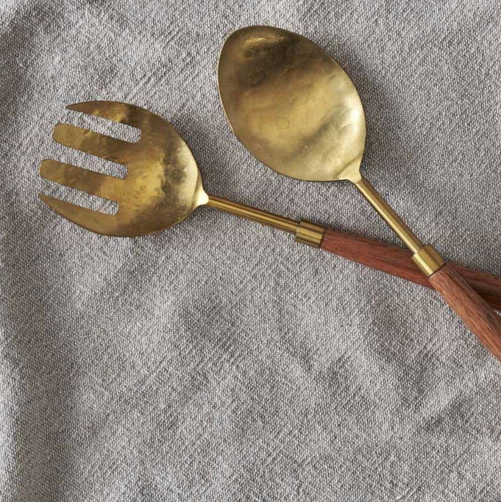 Nkuku Soni Salad Servers in gold and acacia wood, set of 2, featuring elegant handles and natural wooden accents for serving salads.