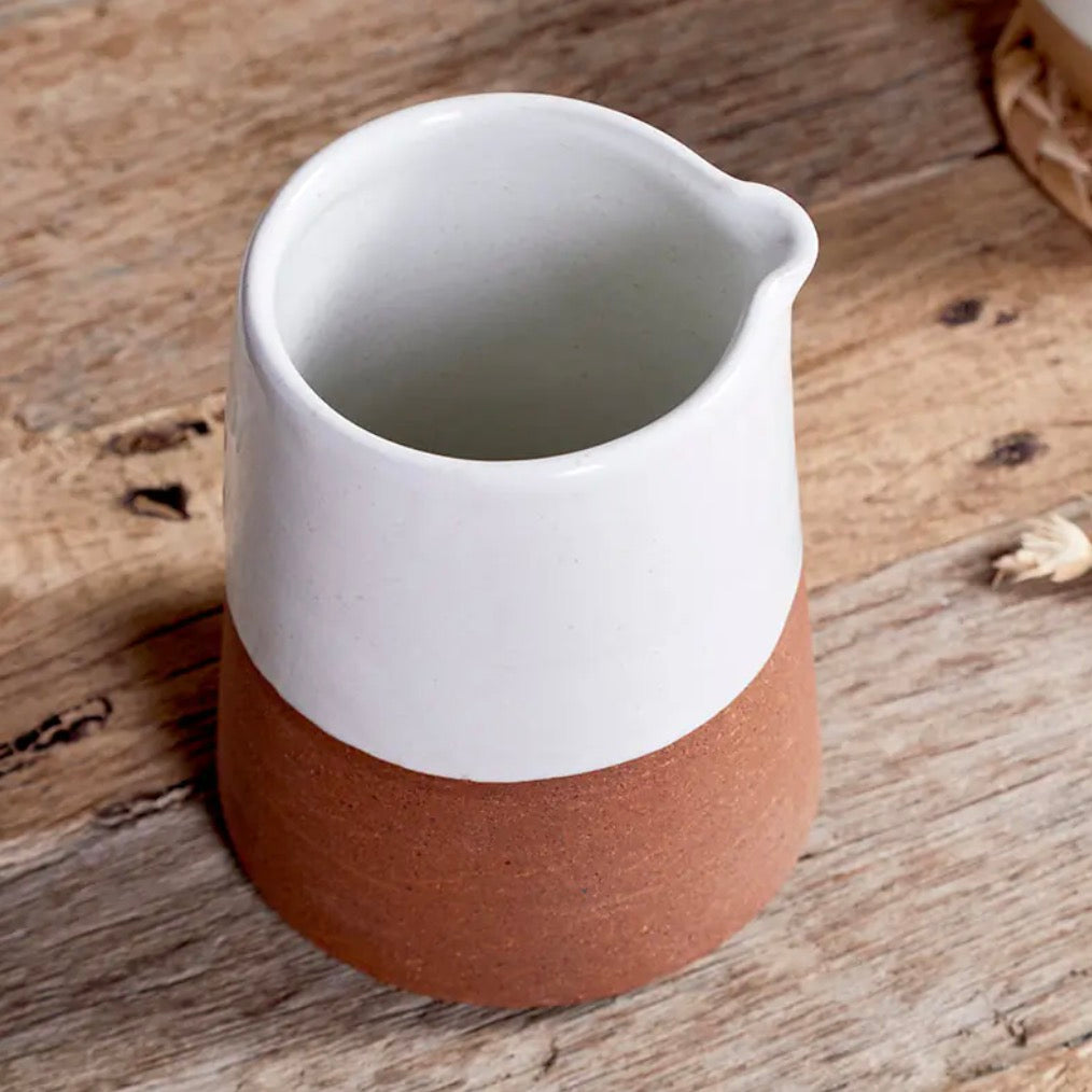 White Mali slanting ceramic jug by Nkuku, featuring a modern, angled design perfect for decorative or functional use.